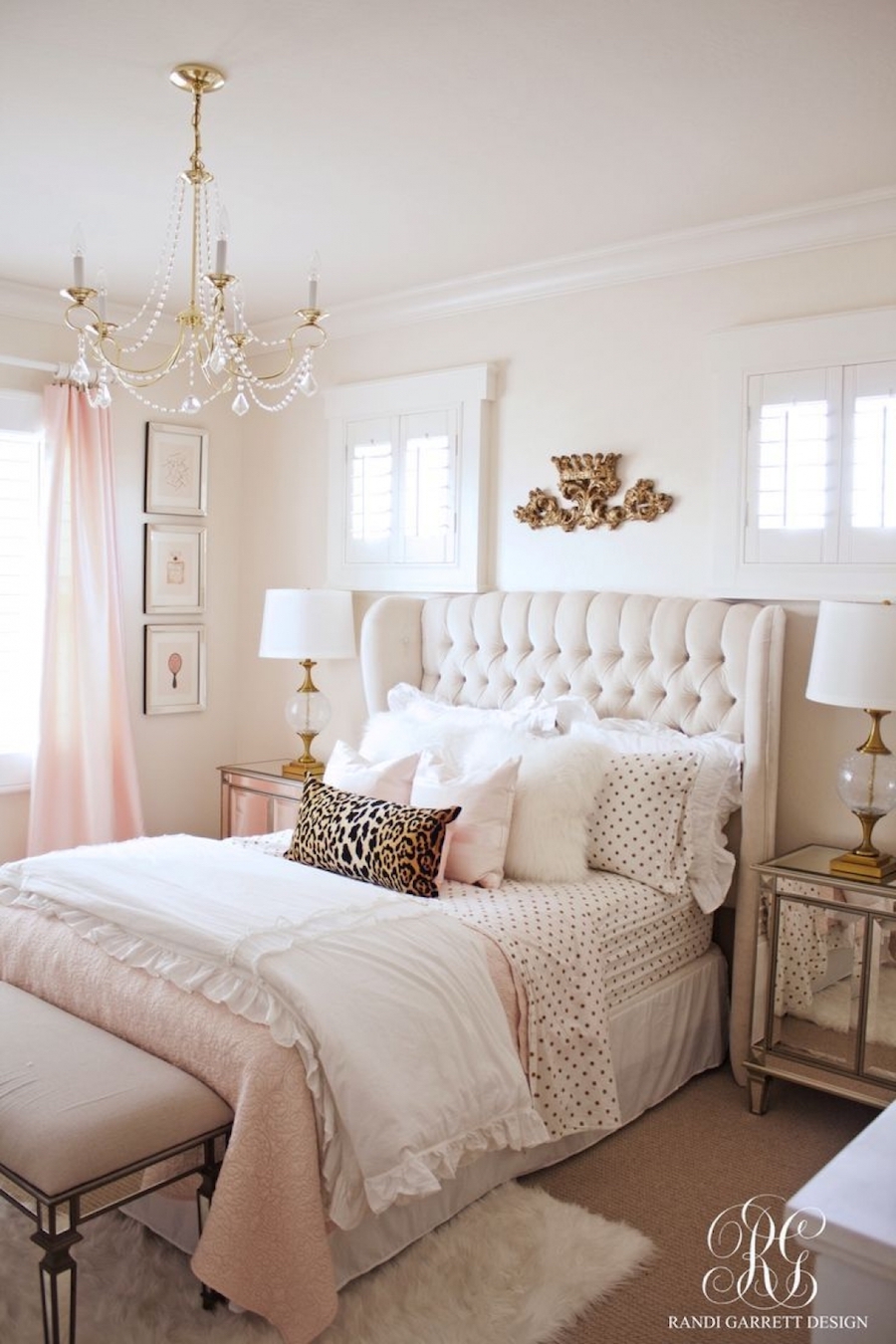 Feminine bedroom with white tufted headboard by Randi Garrett