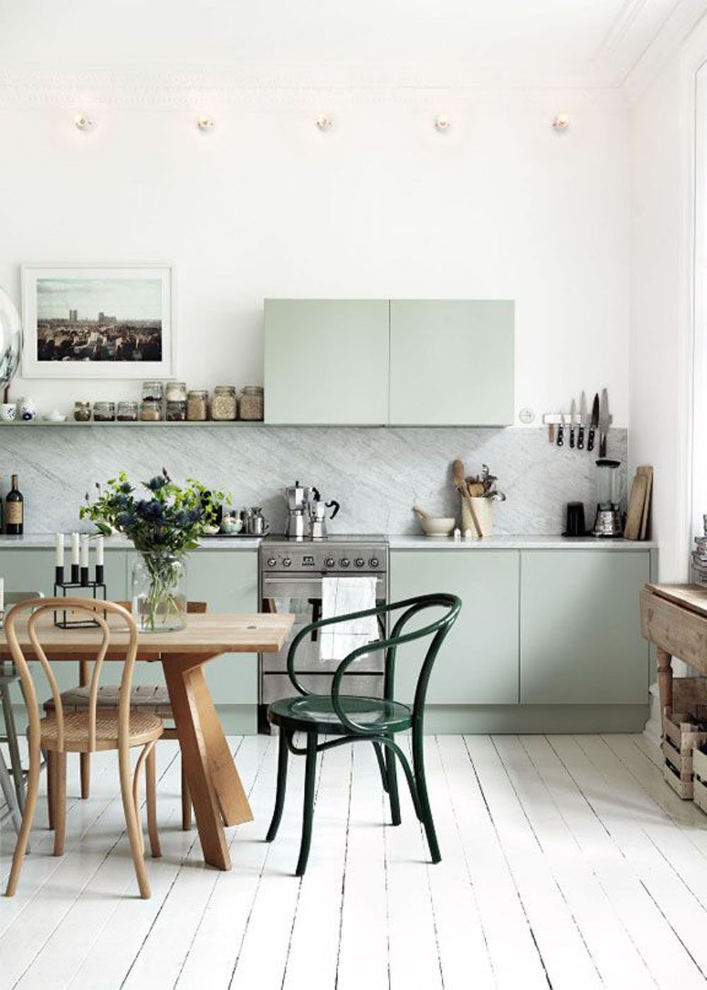 Green bentwood chairs in the kitchen via Petra Bindel