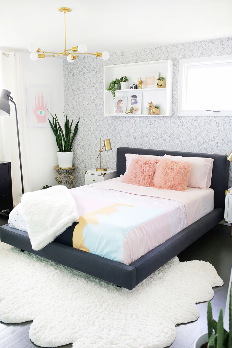 Grey bed with pink fur pillows