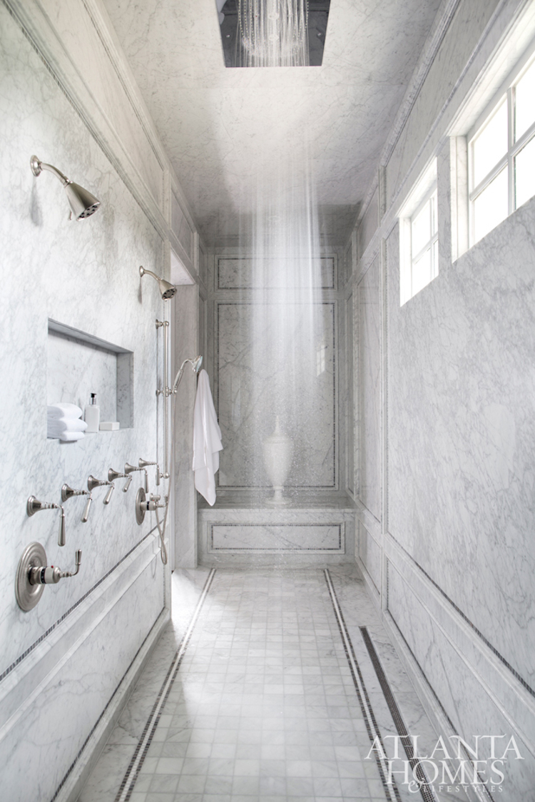 Marble walk-in shower with dark silver fixtures