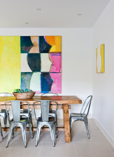 Metal tolix chairs with bright abstract art