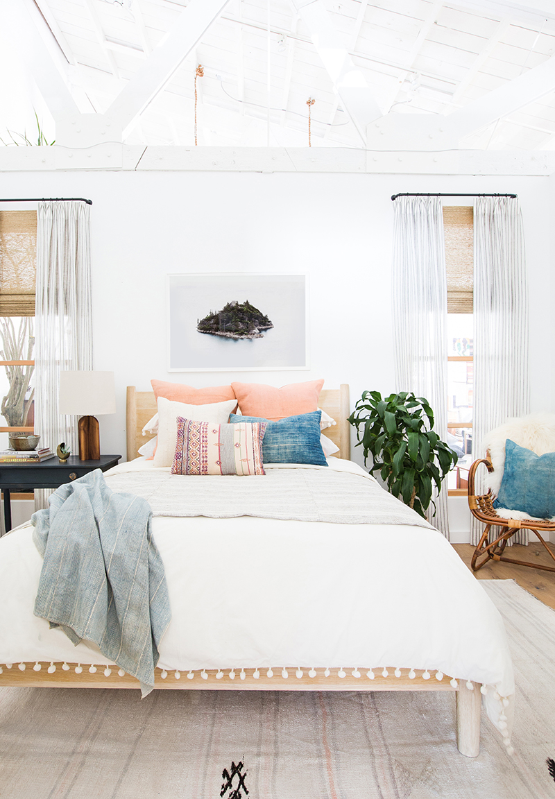 Peach pillows in a bedroom via Amber Interiors