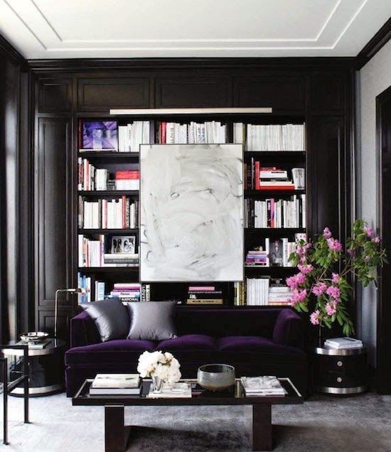 Plum velvet sofa with bookcase and white art