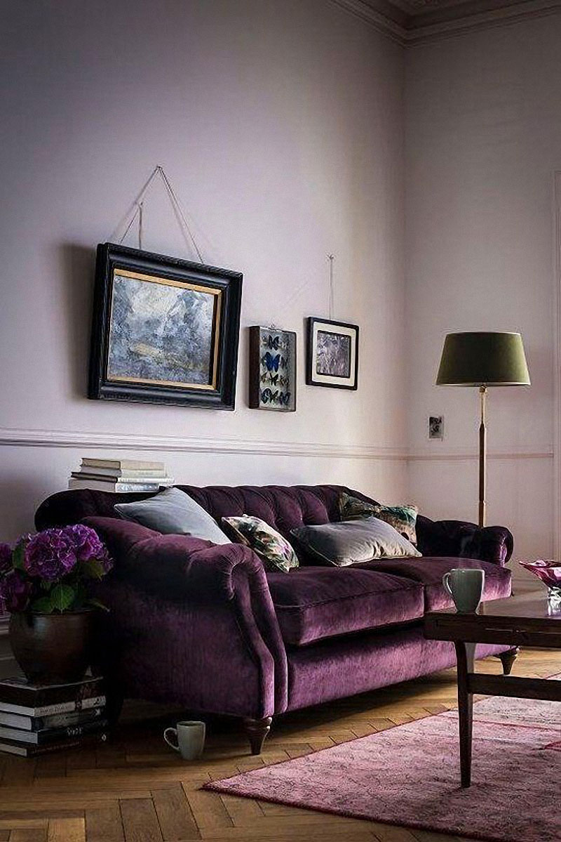 Purple tufted velvet sofa with lavender walls