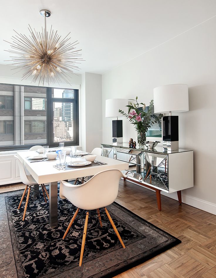 Silver starburst chandelier in white and grey dining room