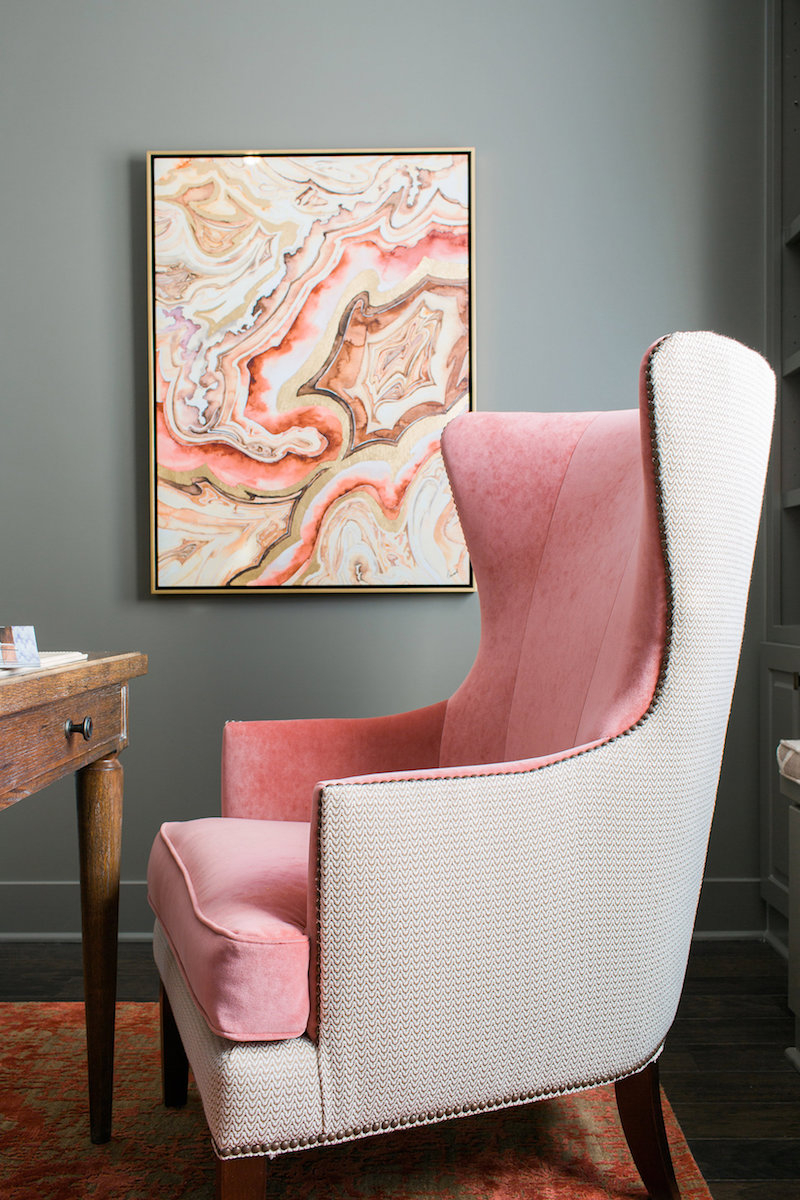 Soft pink wingback chair with marble artwork