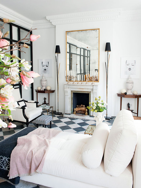 Spanish apartment with vintage fireplace and white chaise lounge