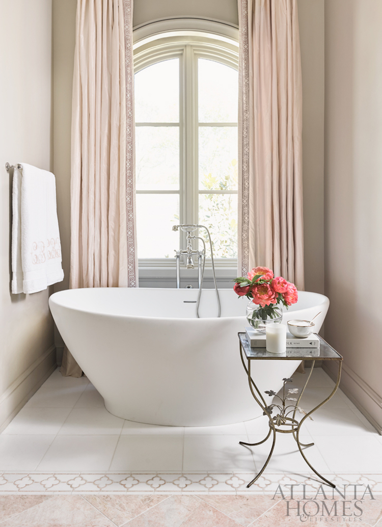 White freestanding bathtub with blush pink curtains