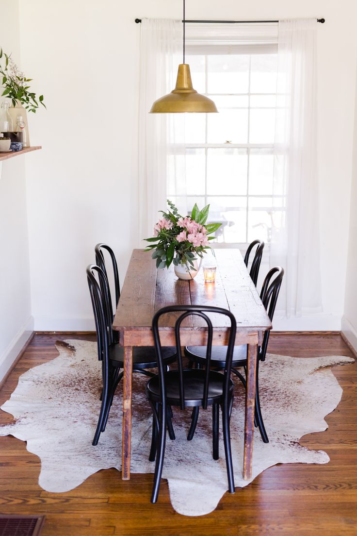 Wood dining table with black bentwood chairs