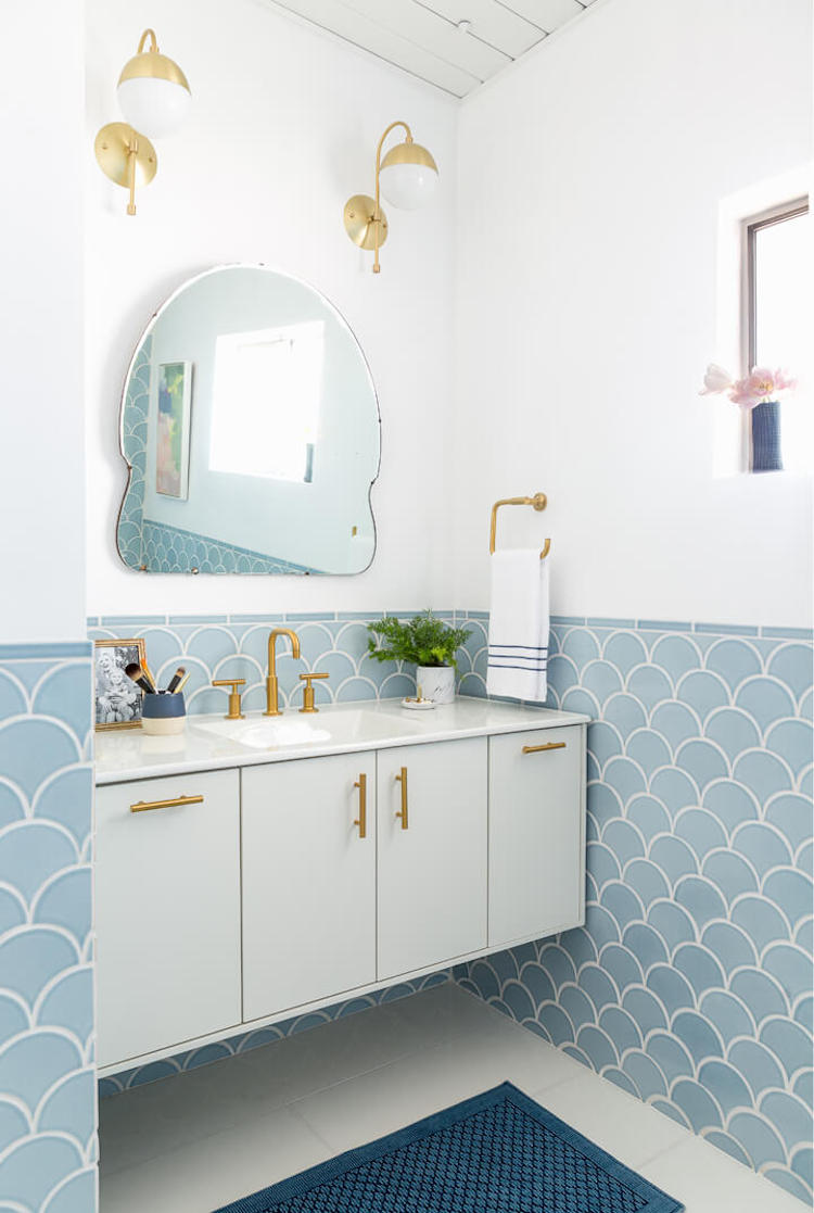 Bathroom with half wall of blue scallop tiling