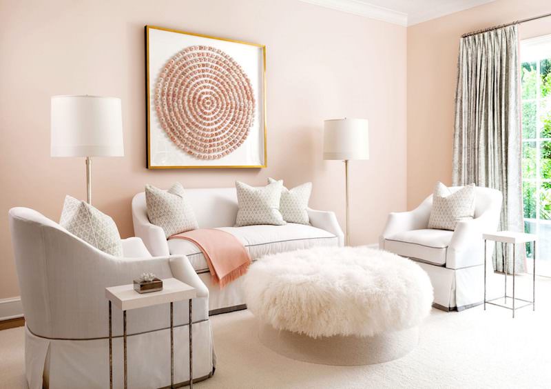 Blush pink wall living room with white sofas and pink art