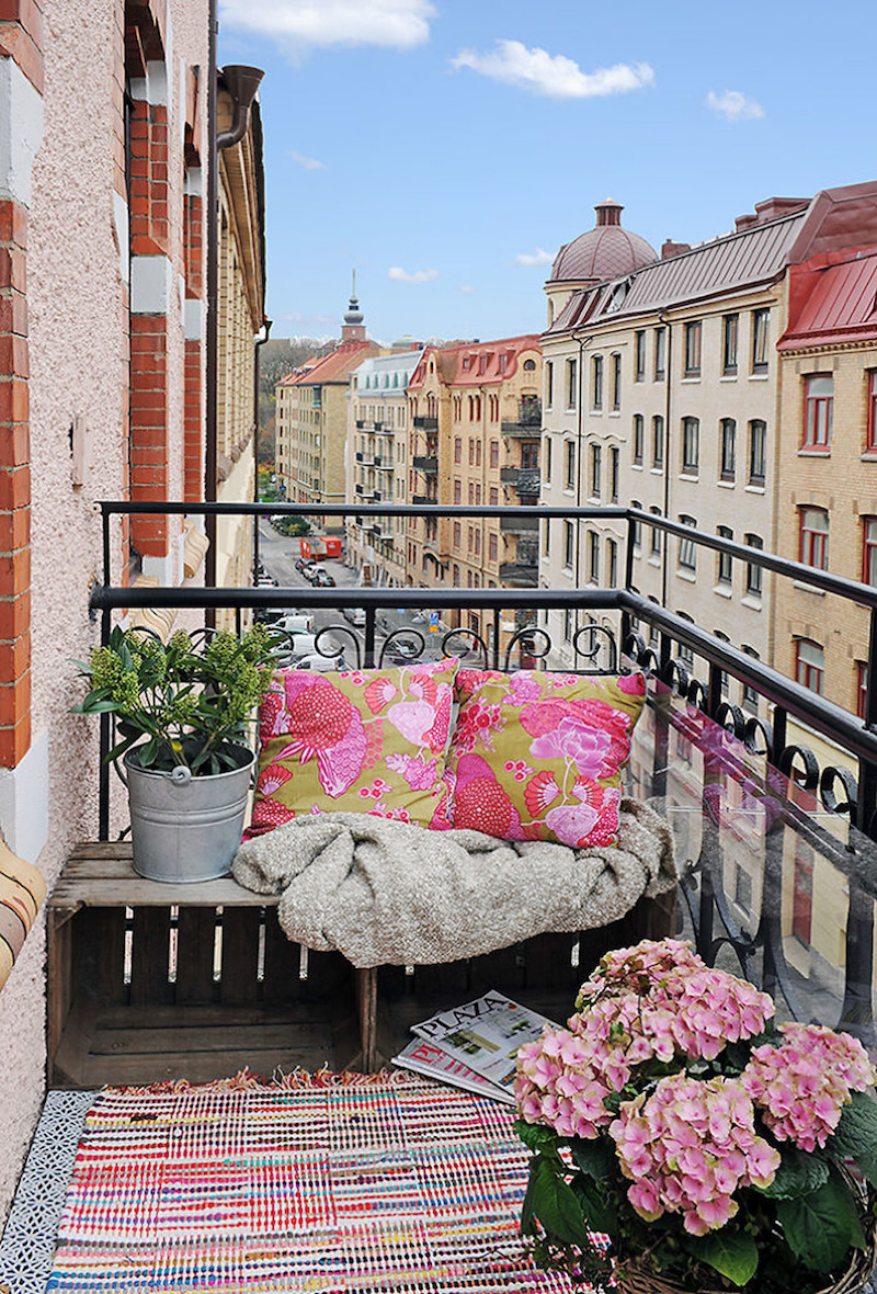 City balcony with pink pillows