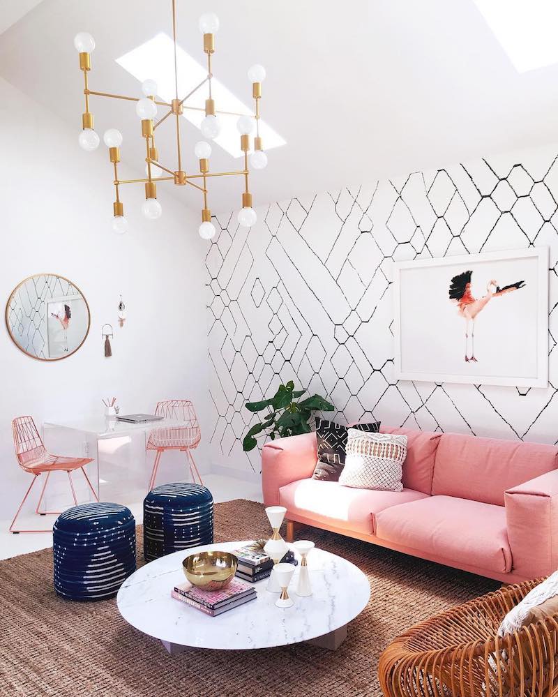 Pink sofa with marble coffee table and branch gold lighting