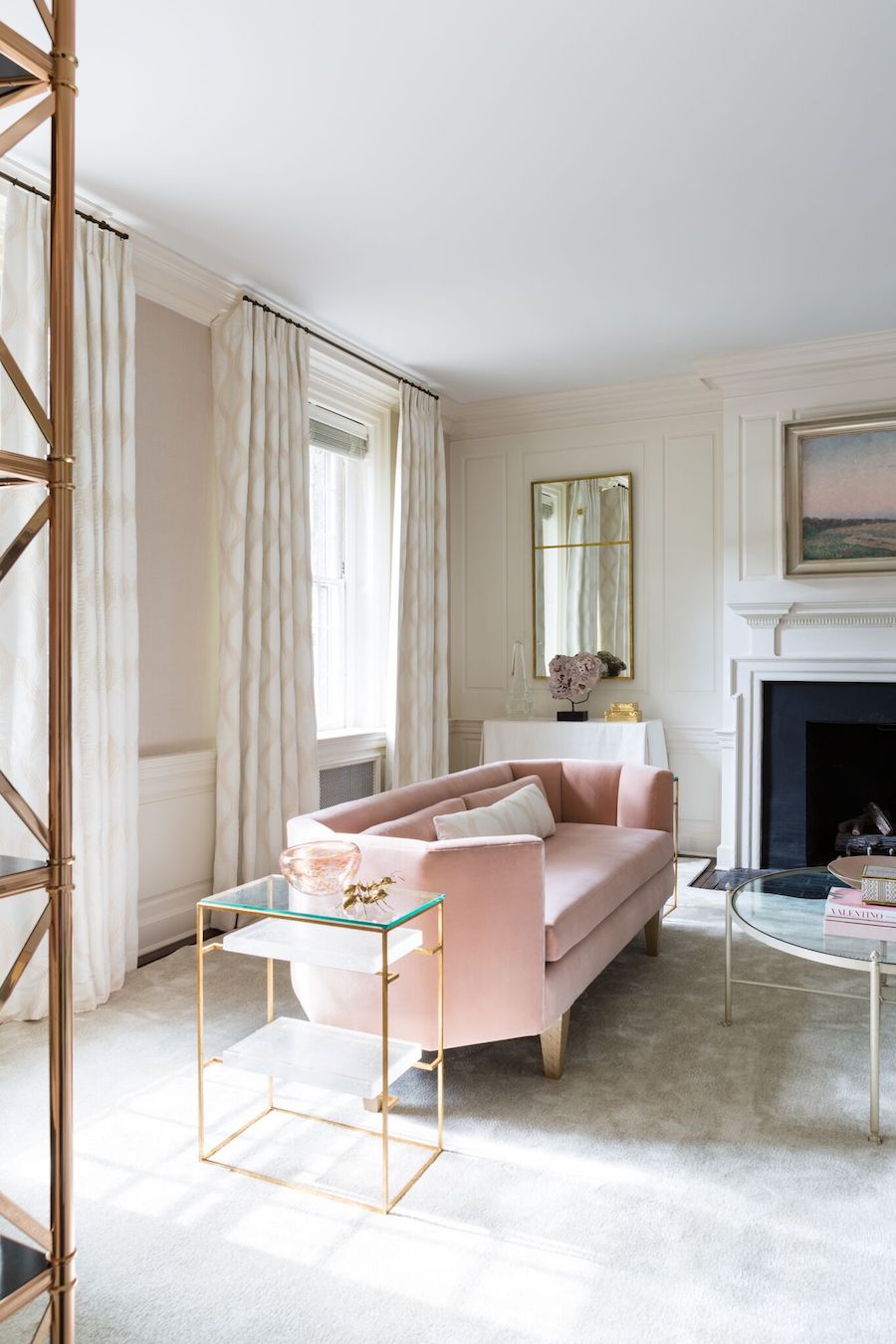 Soft pink sofa with beige curtains and gold side table