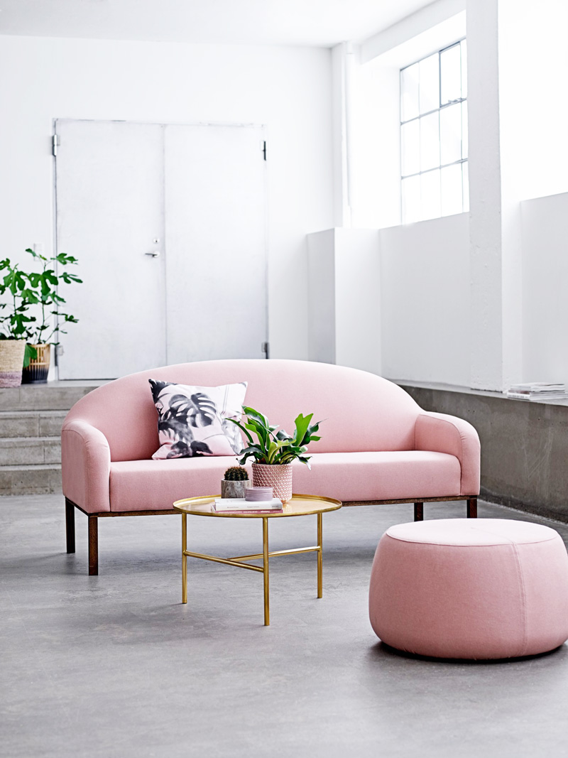 Soft pink sofa with gold coffee table