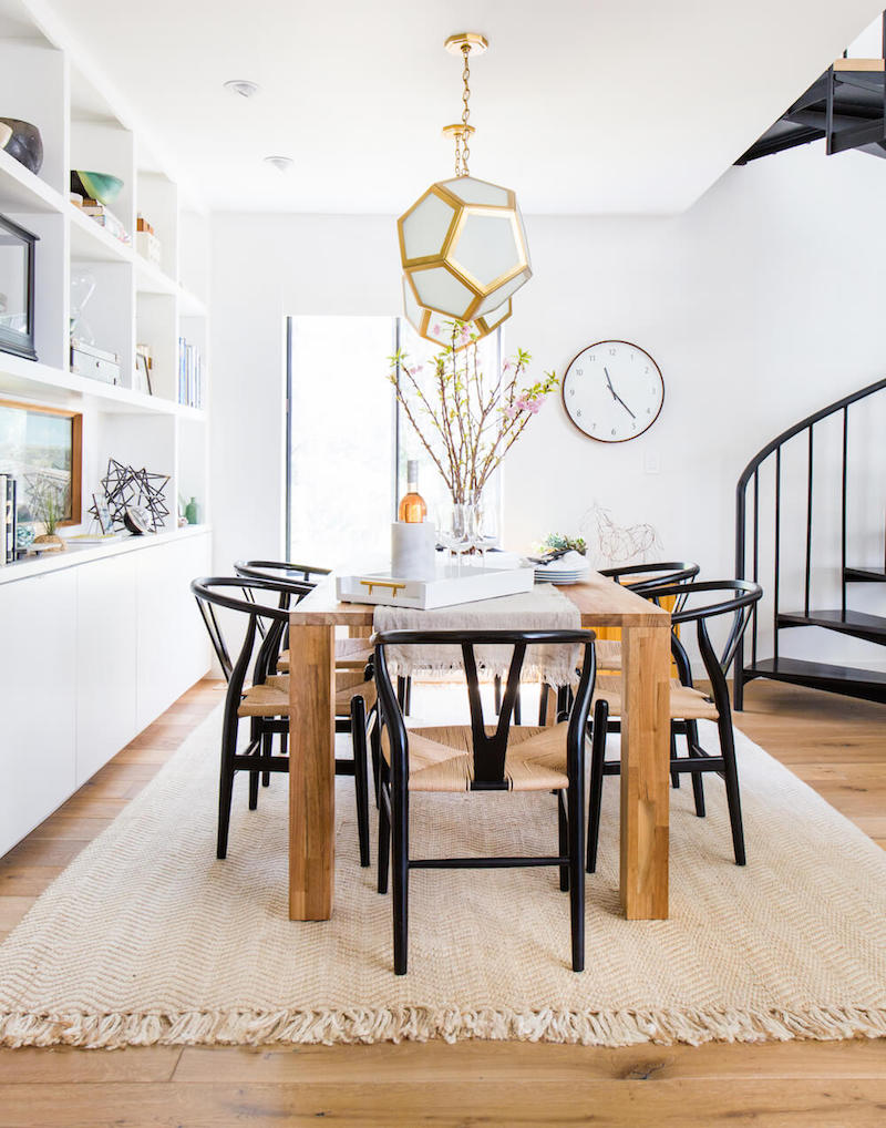 Black wishbone chairs in neutral dining room via Emily Henderson