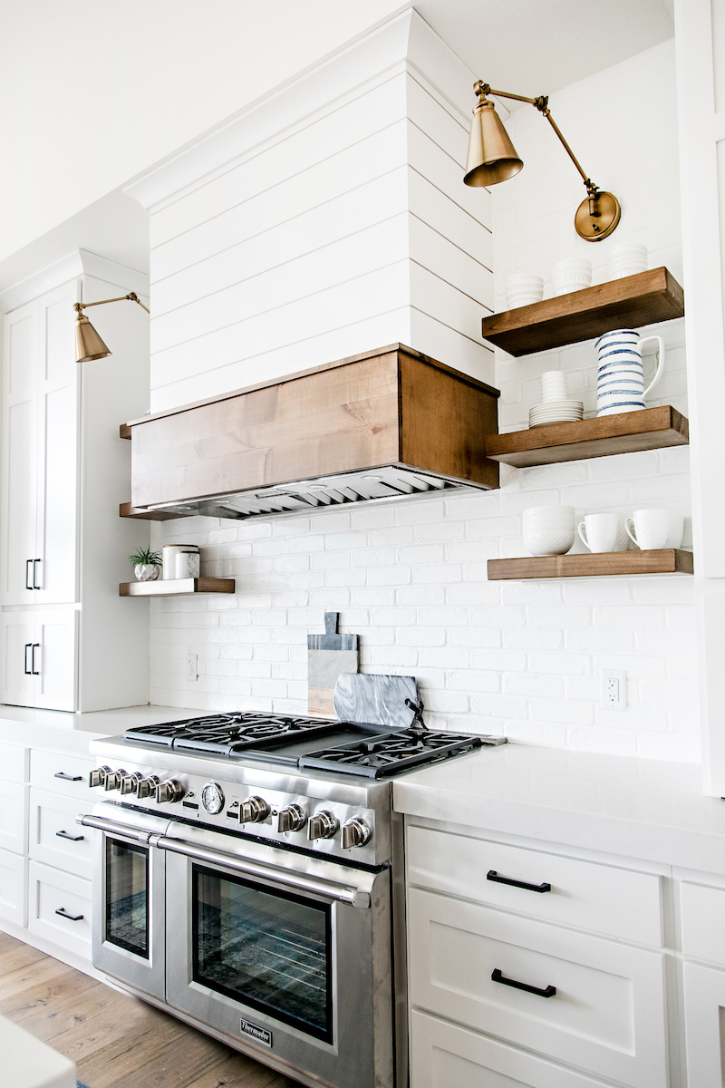 Brass sconces in white kitchen via Sita Montgomery