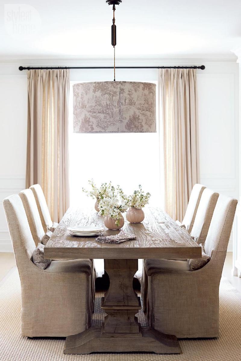 Neutral dining room with wood table