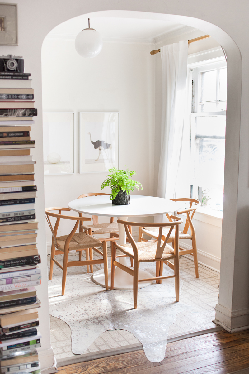 Neutral wishbone chairs in dining room via The Every Girl