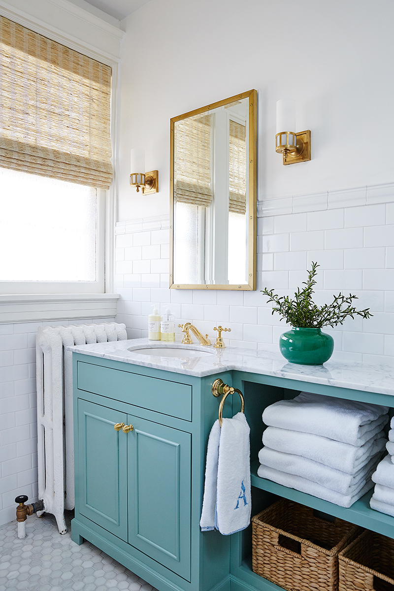 Turquoise bathroom vanity with bronze sconces via Amie Corley