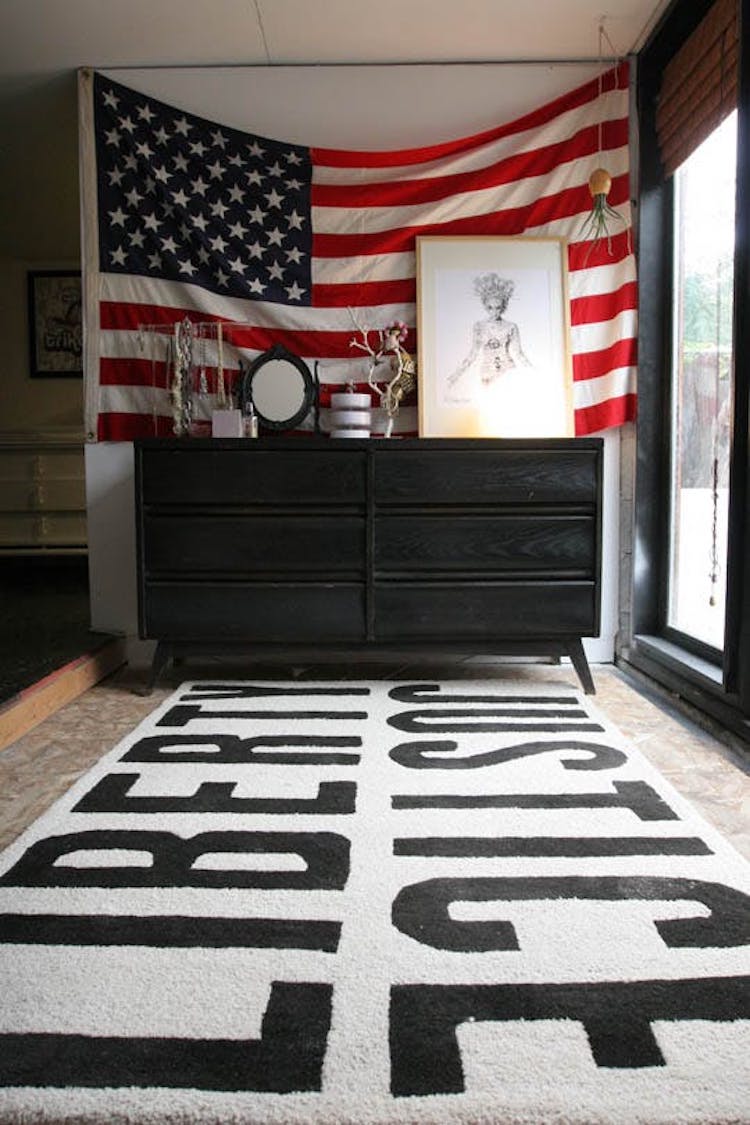 American flag behind black dresser via Apartment Therapy