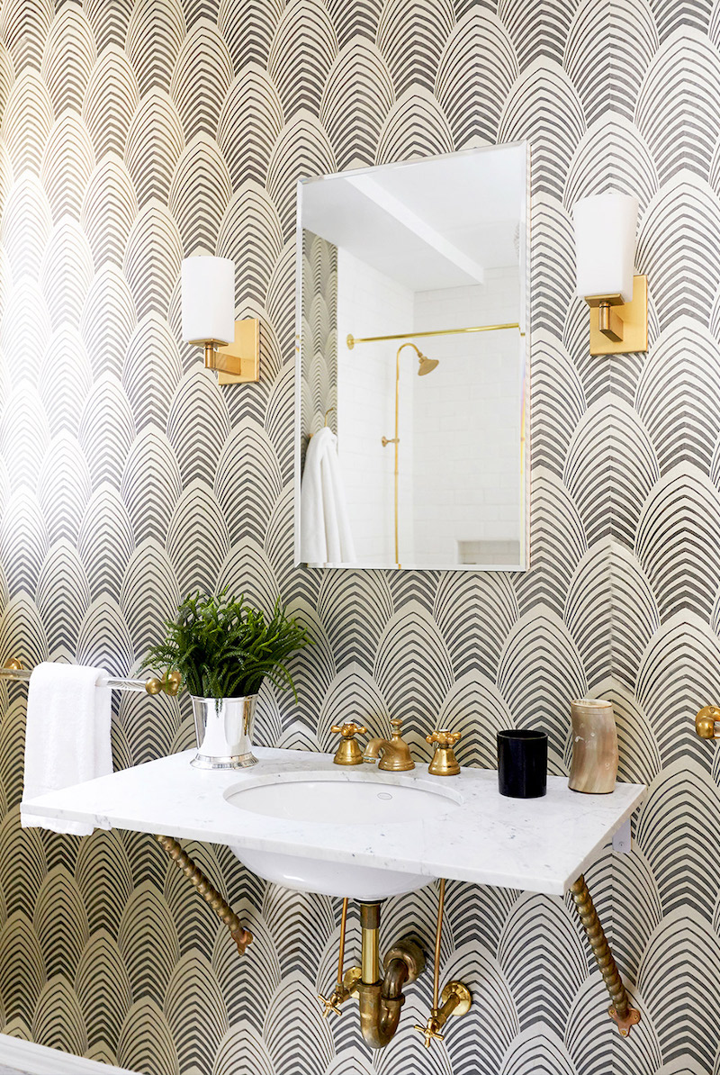 Bathroom sink with gold finishes and Farrow & Ball wallpaper