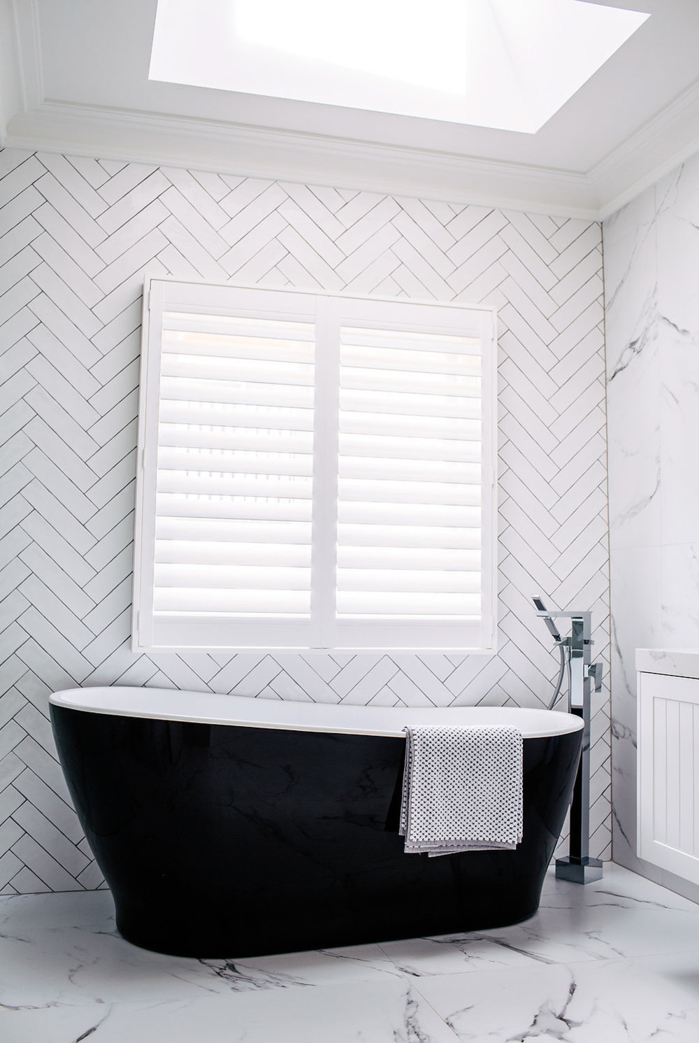 Bathroom with black freestanding tub