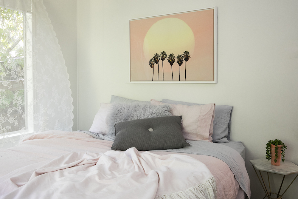 Bedroom with pink and sunset by Three Birds Renovations