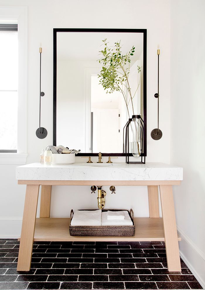 Black floor tiles in well-lit bathroom via Tamara Magel