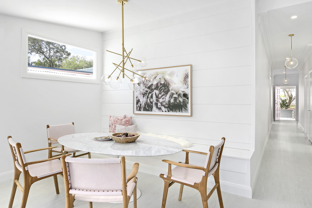 Dining room with marble table and pale pink chairs