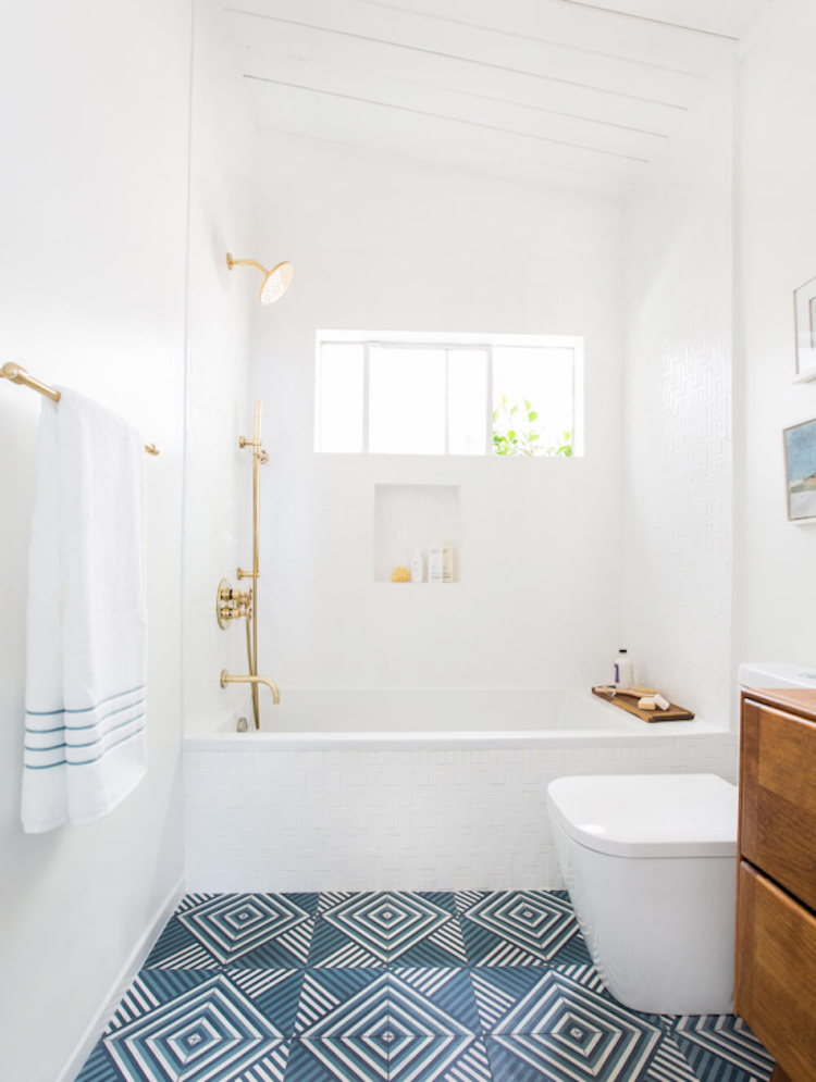 Emily Henderson’s guest bathroom with gold fixtures and blue tile floor