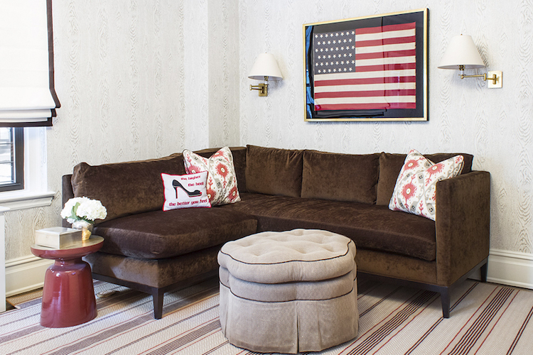 Framed American flag with brown sofa