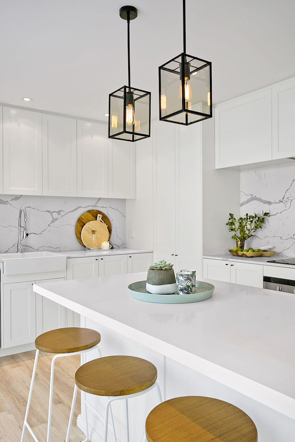 Kitchen with two black pendant lights via Three Birds Renovations