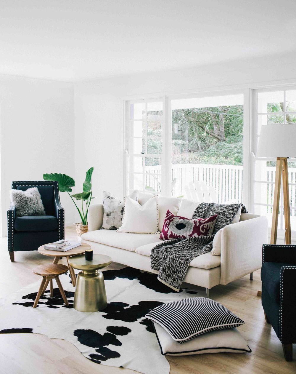 Living room with cream white couch and cowhide rug