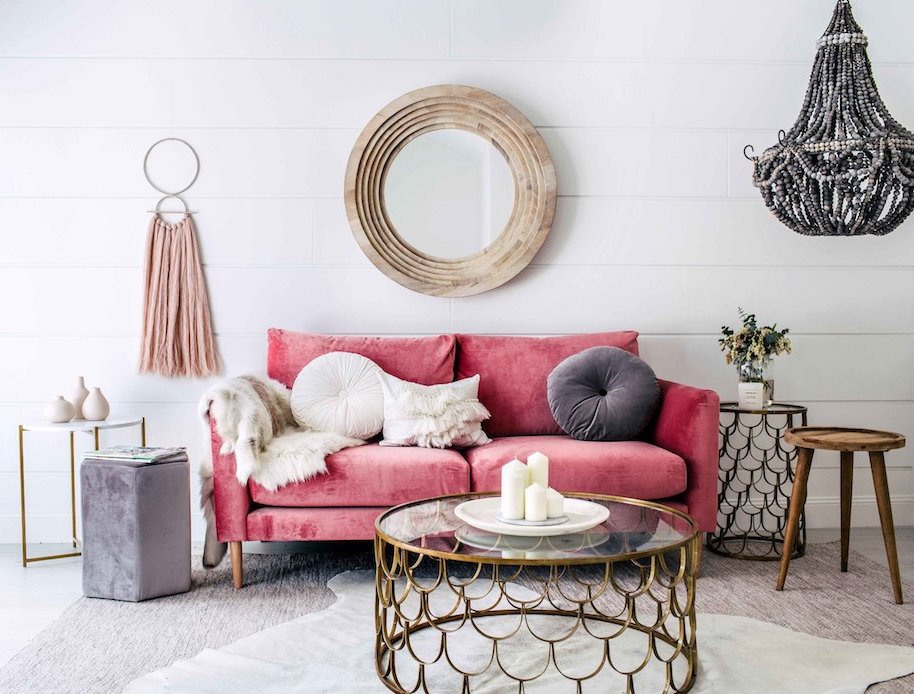 Living room with pink sofa via Three Birds Renovations