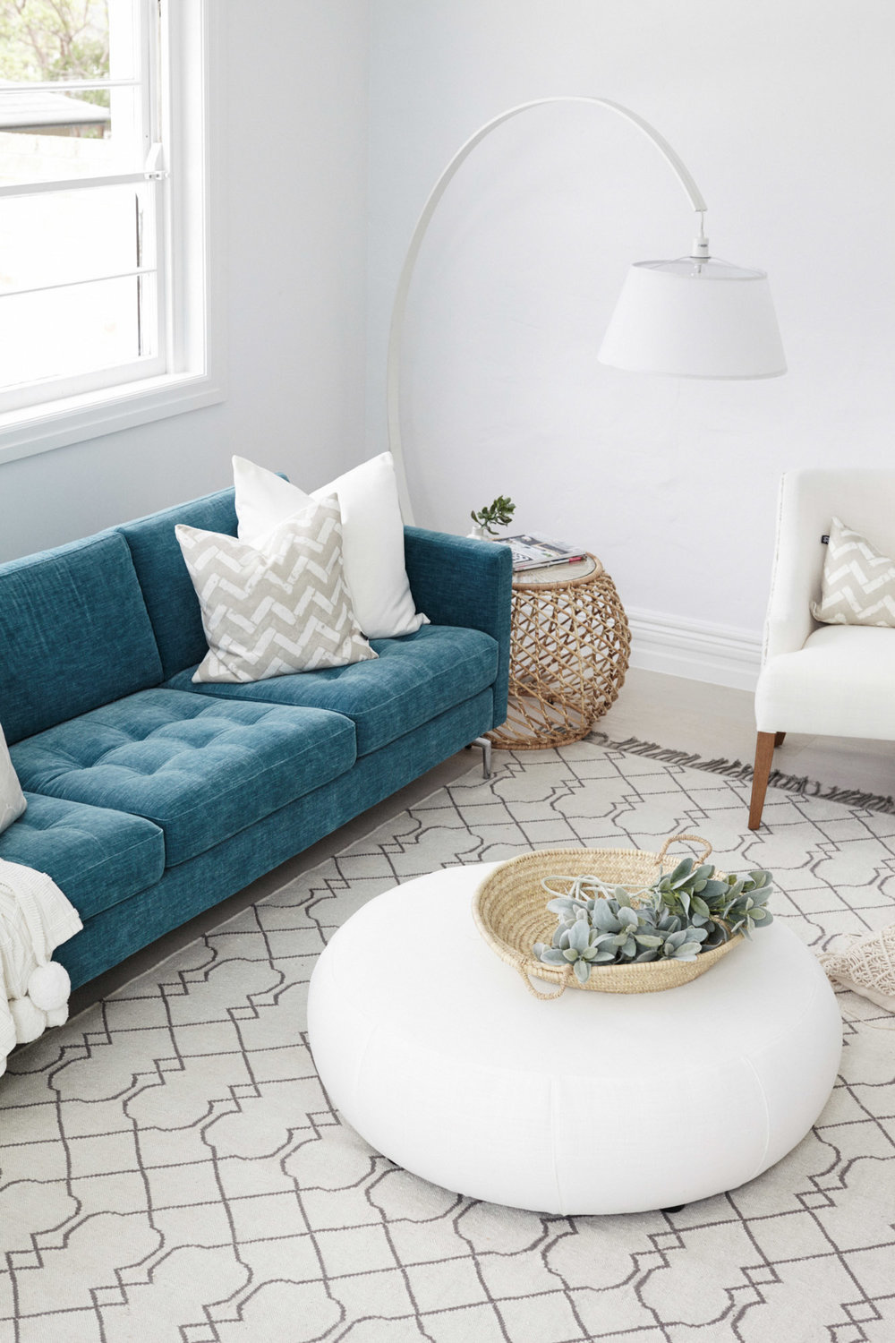 Living room with teal couch and overhang light