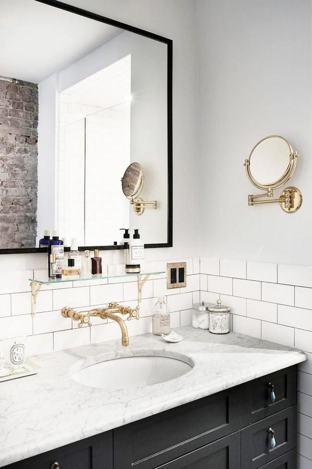 Marble bathroom counter with black cabinets via Pia Ulin for Vogue