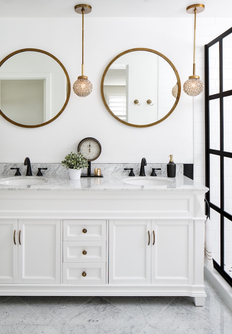 Marble bathroom vanity with gold mirror