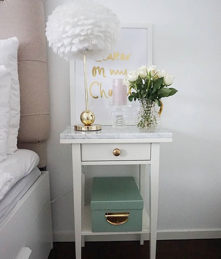 Marble top nightstand with gold feather lamp