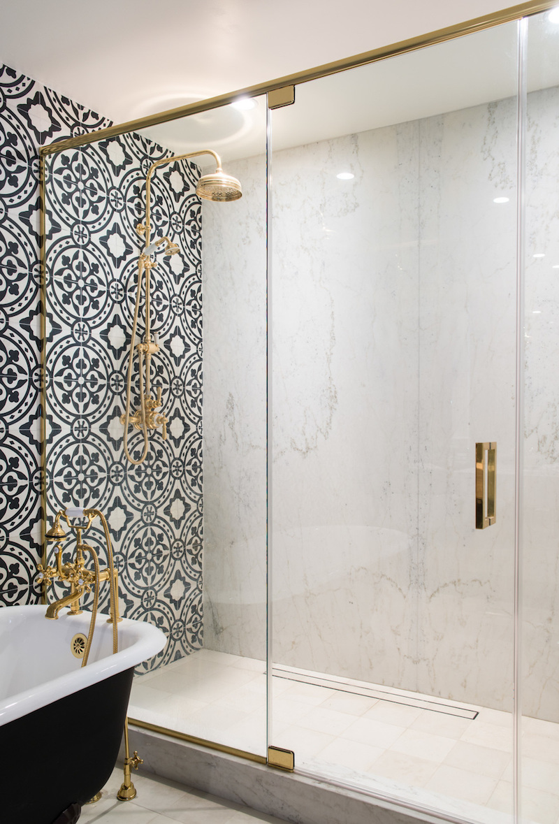 Spanish tiling in bathroom with black tub