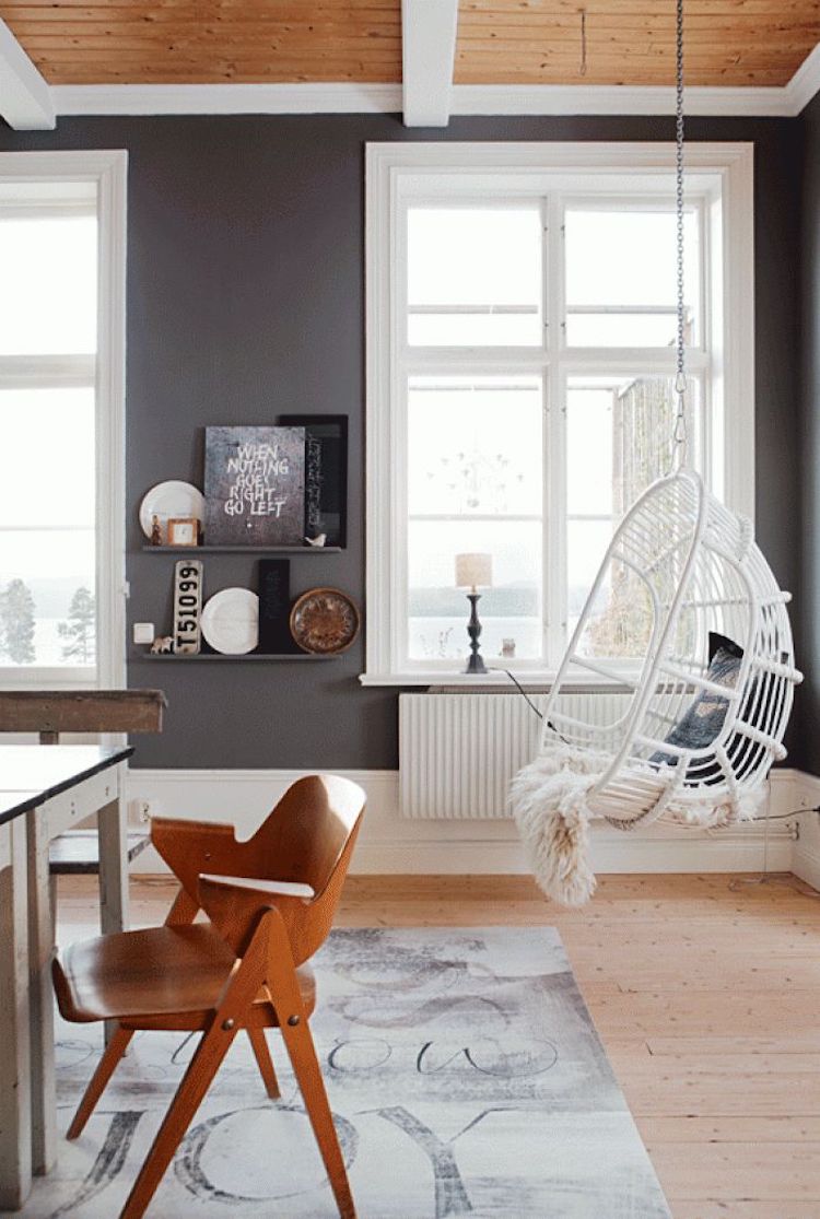 White hanging rattan chair in wood ceiling room