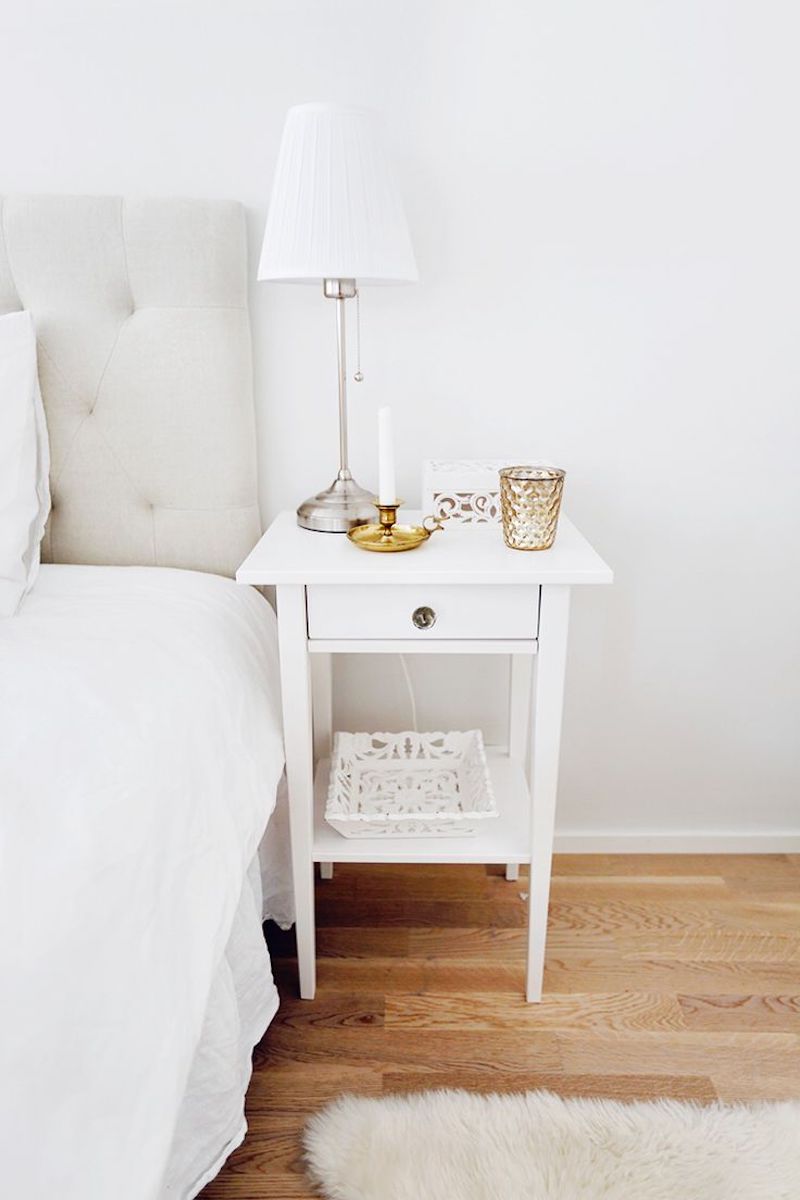 White minimal nightstand with lamp and candle