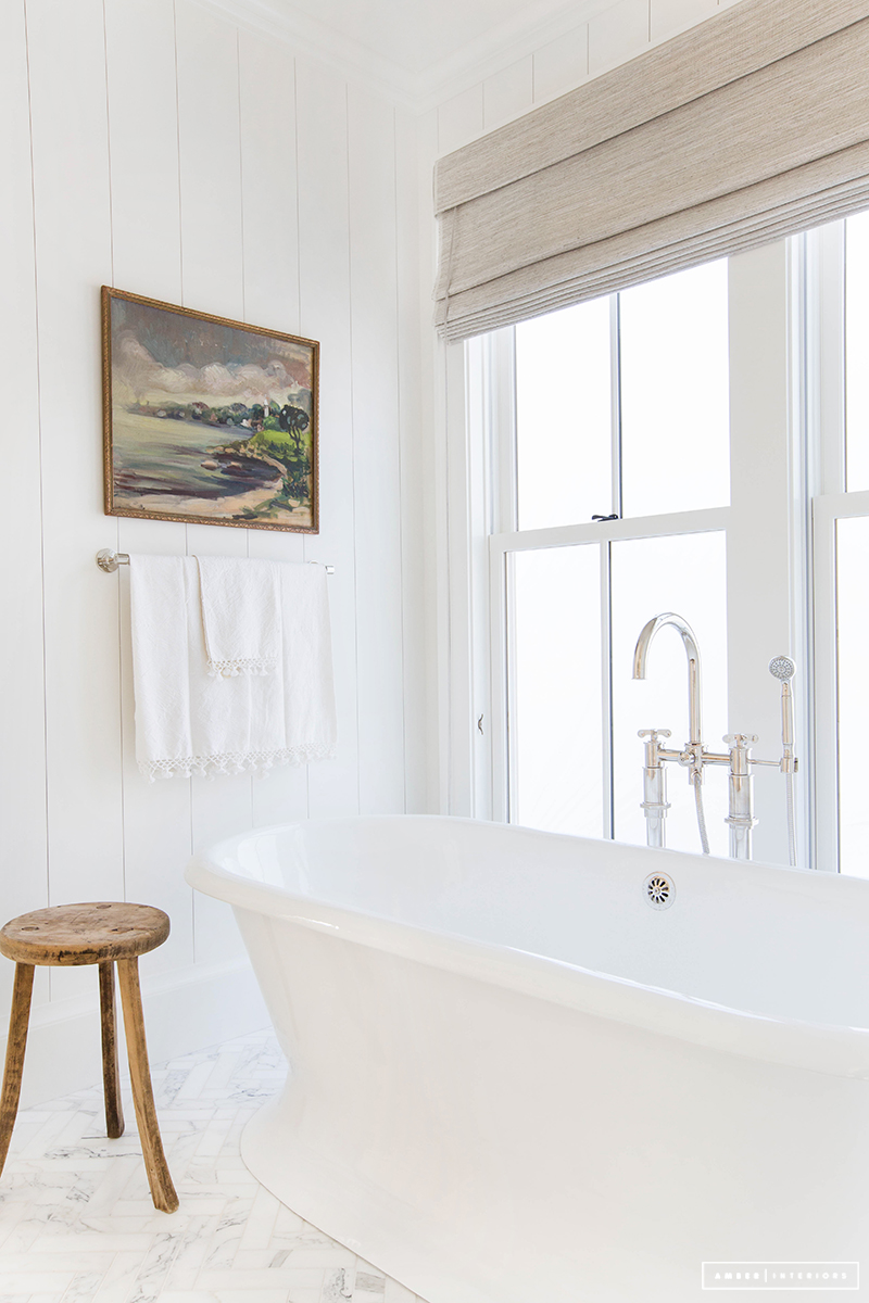 Simple white freestanding bathtub via amberinteriordesign