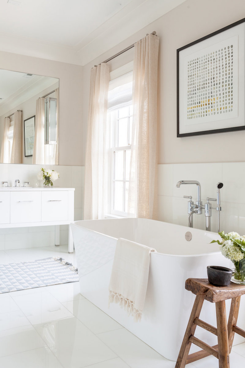 White bathtub in neutral bathroom via chango and co