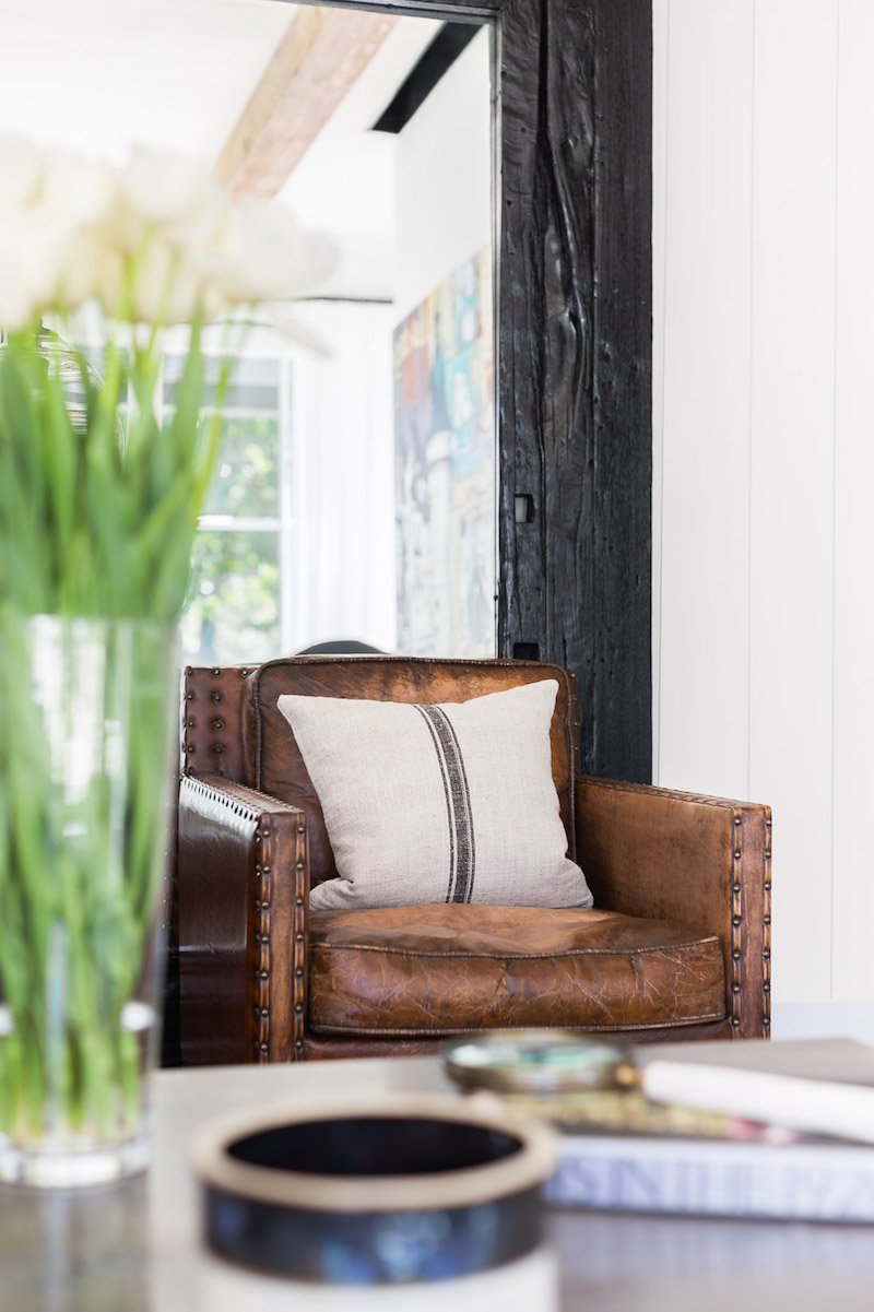 Brown leather chair with Farmhouse throw pillow in the living room