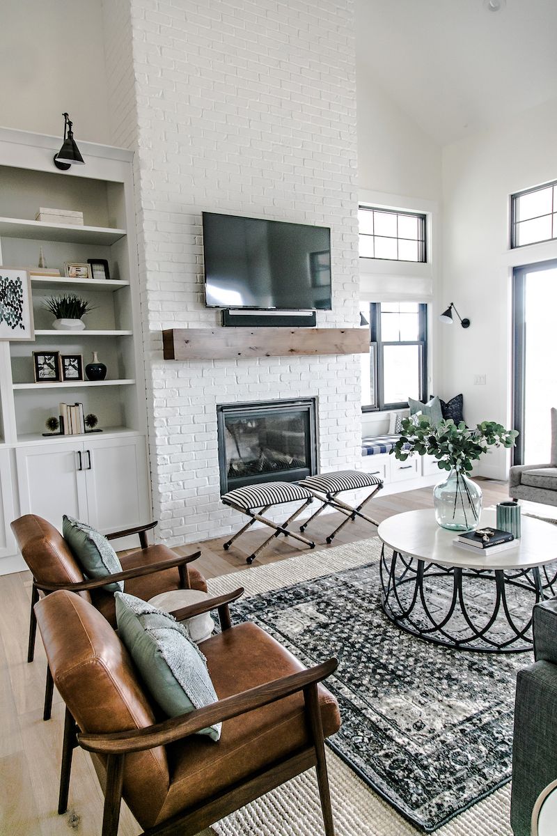 Two matching brown mid-century leather chairs in Farmhouse living room