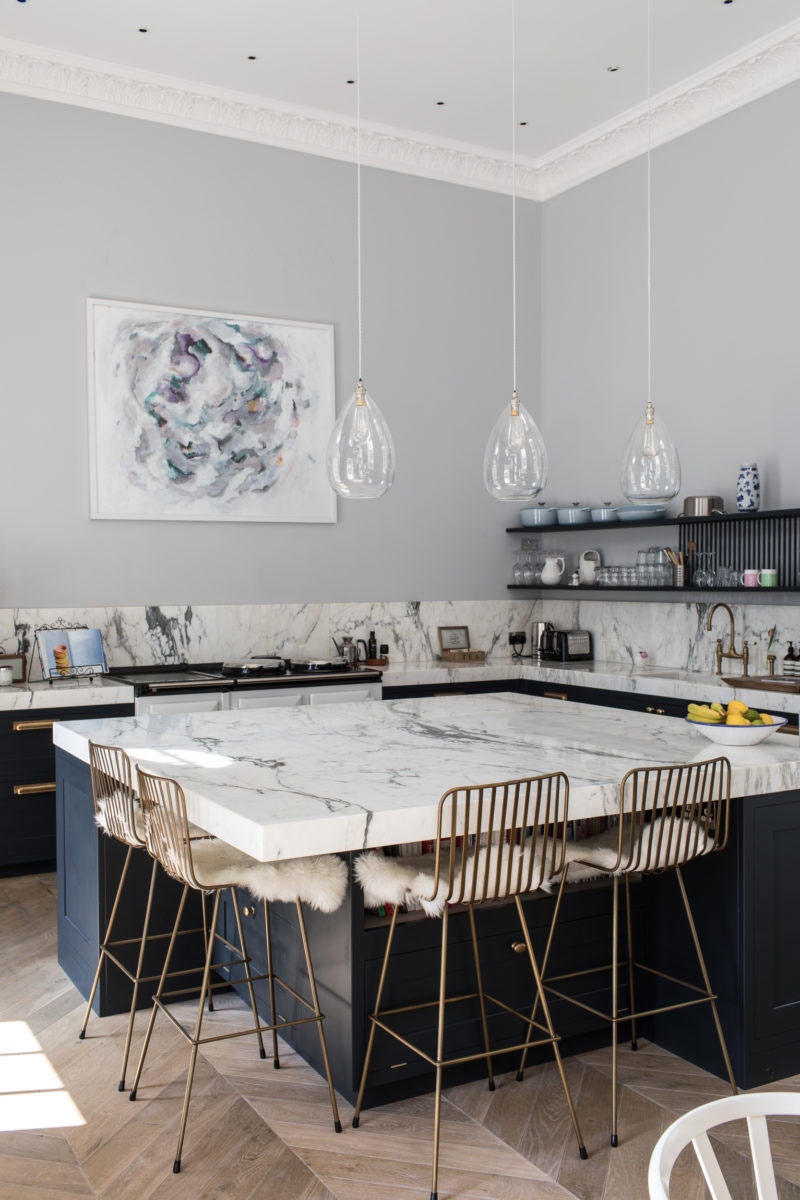 Marble Kitchen Island in Kitchen with Open Shelving Photo by Patrick Butler-Madden