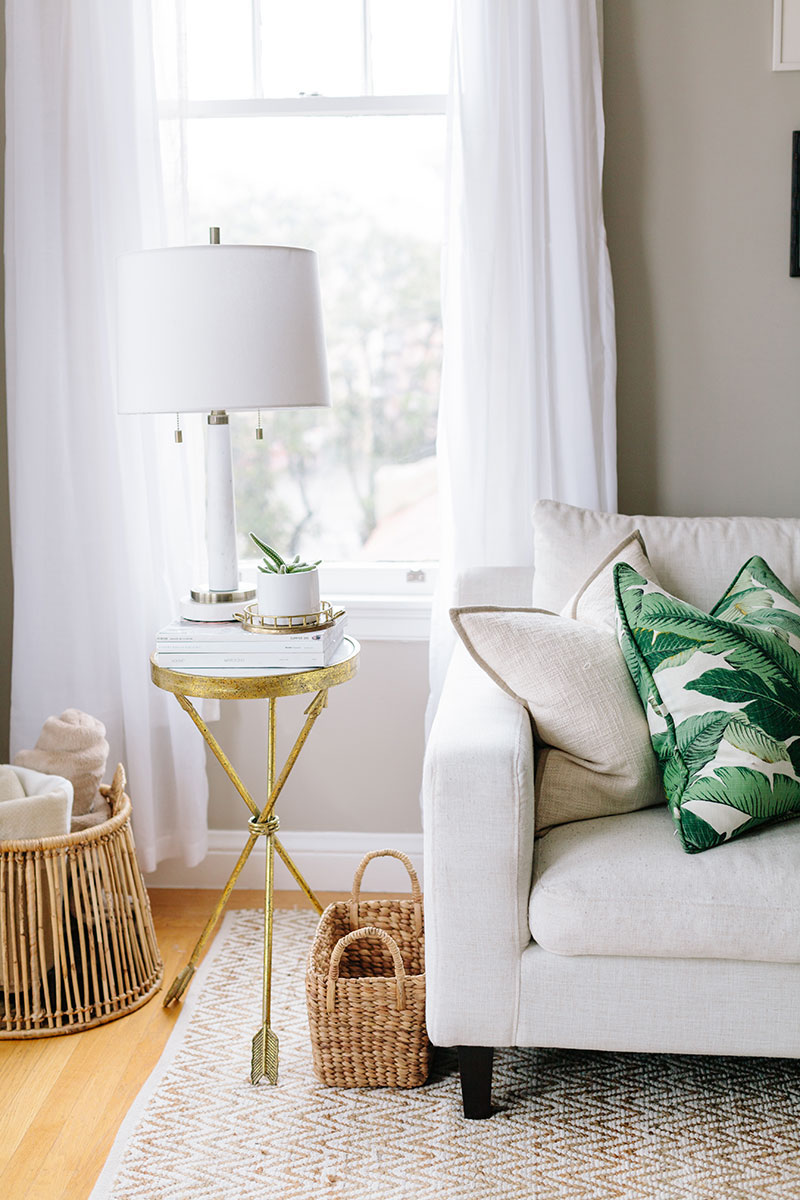 Beige Sofa With Gold Side Table And Palm Tree Pillow