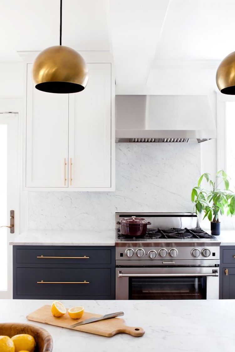 Brass kitchen with solid white marble backsplash via Jennifer Hughes