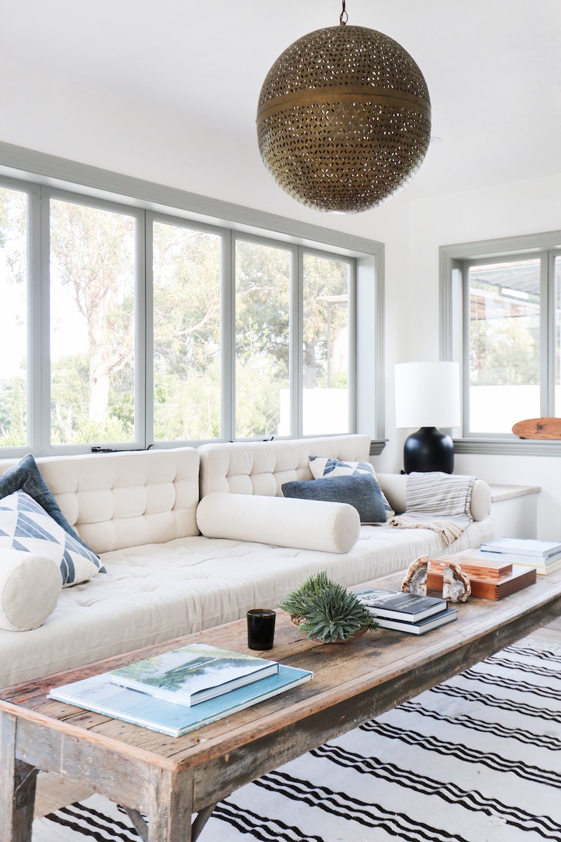 Tufted Beige Sofa with striped rug and rustic wood coffee table via Alexander Design